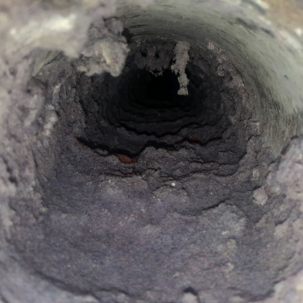 Clogged dryer vent filled with lint before professional dryer vent cleaning in Quincy IL