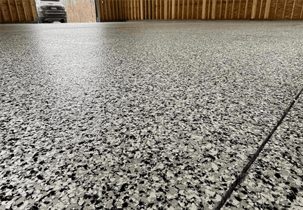 Decorative chip garage floor coating installed in a residential garage in Quincy IL