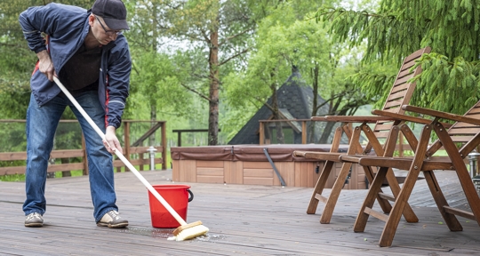 man cleaning the deck