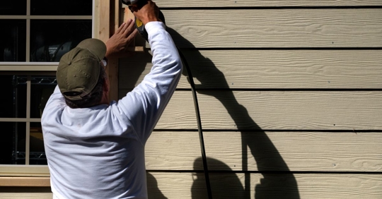 man installing siding